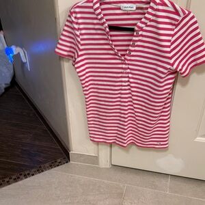 Calvin Klein Pink and White Striped Polo shirt with front snaps.